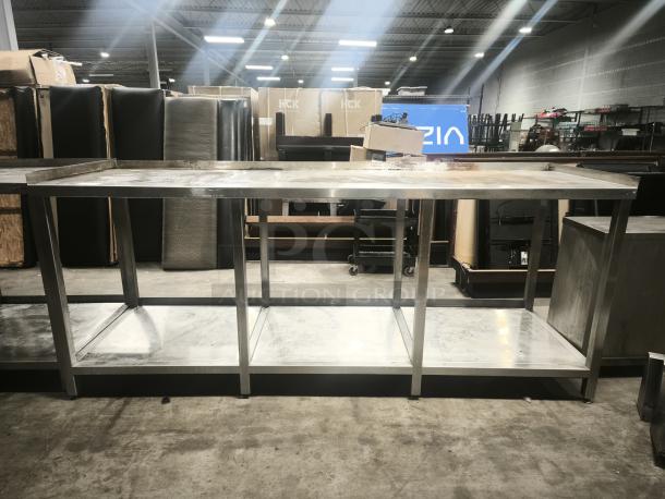 Stainless steel table with one lower shelf. Good condition, industrial design, rectangular shape. Ideal for kitchen or workshop use.