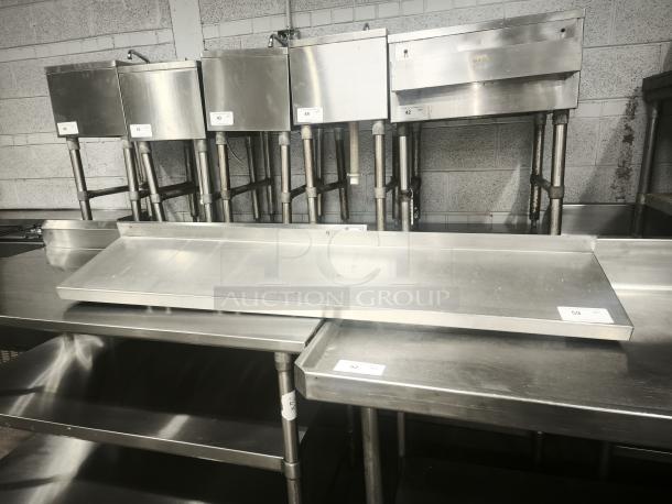 Stainless steel kitchen shelf, durable and sleek, in excellent condition. Features sturdy construction, ideal for commercial use.