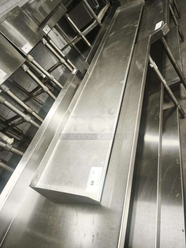 Stainless steel kitchen shelf, rectangular, industrial design, slight scratches, labeled "69 QTY". Ideal for commercial use.