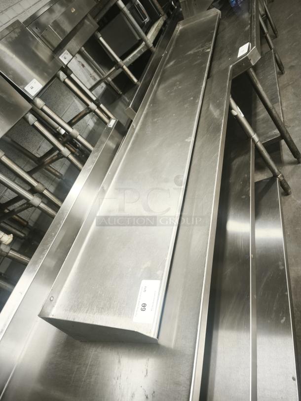 Stainless steel kitchen shelf in good condition, rectangular design, with visible tag labeled "69" for auction reference.