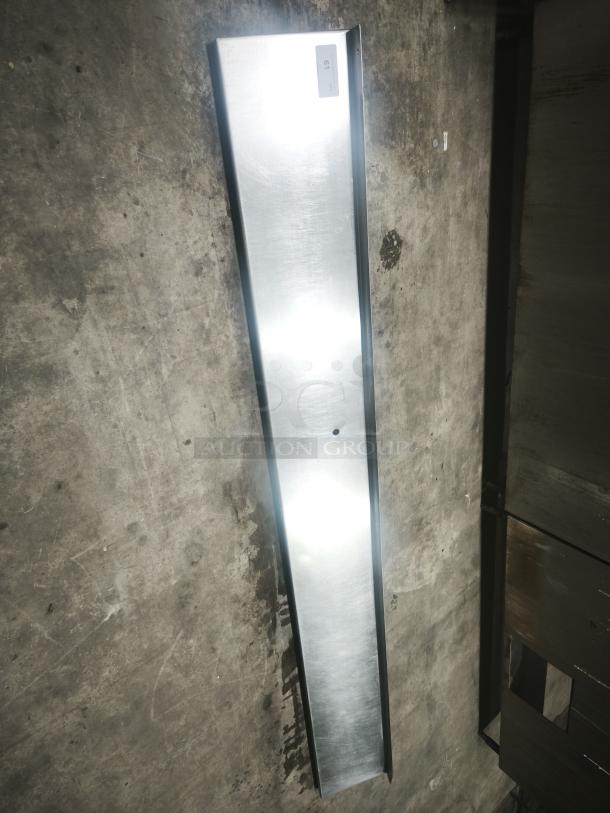 Stainless steel kitchen shelf, long and sleek, with a reflective surface. Good condition, labeled with ID tag "10".