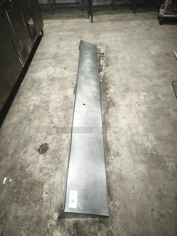 Stainless steel kitchen shelf, long rectangular shape, clean surface, numbered tag "61" visible, good condition.