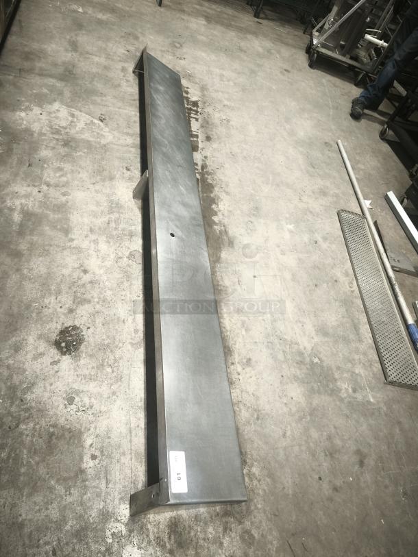 Stainless steel kitchen shelf with a label marked "69." Durable construction, good condition, suitable for home or commercial use.