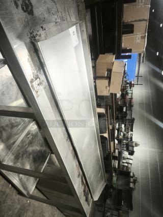 Stainless steel kitchen shelf in used condition with surface marks. Includes auction tag labeled "63".