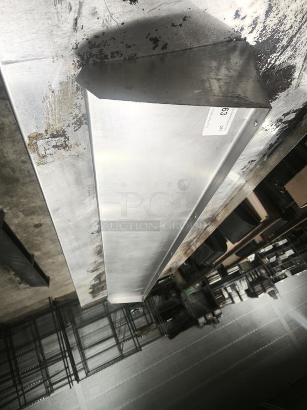 Stainless steel kitchen shelf, industrial style, with a brushed finish. Visible wear on surface; label reads "63 QTY".