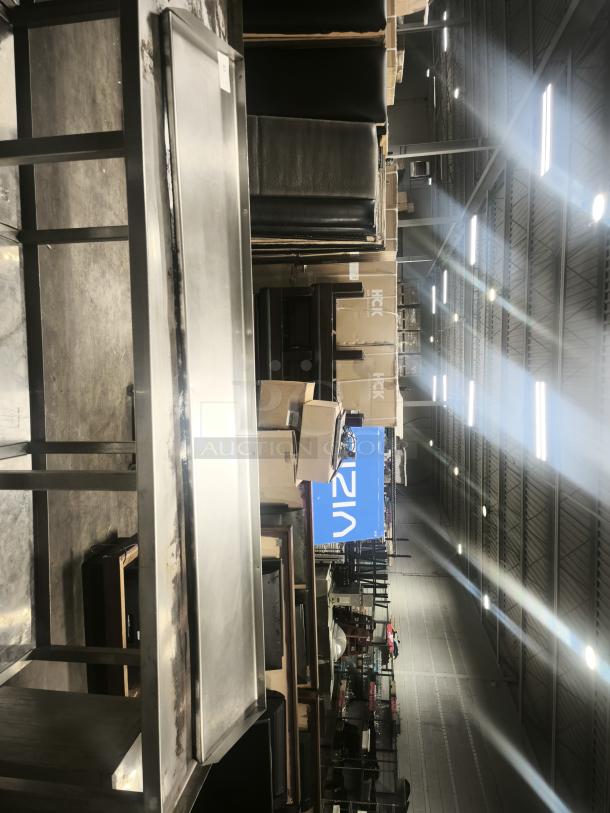 Stainless steel kitchen shelf, rectangular, durable, in good condition, suitable for commercial or home use.