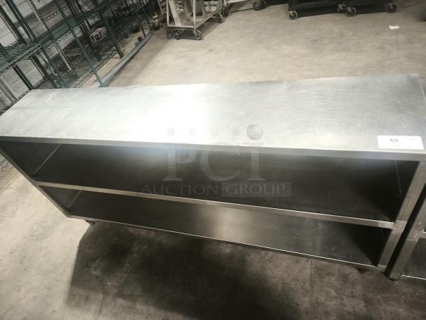 Dish storage cabinet, 60"x15", stainless steel top, 18 gauge; features two shelves, label "65" visible, pristine condition.