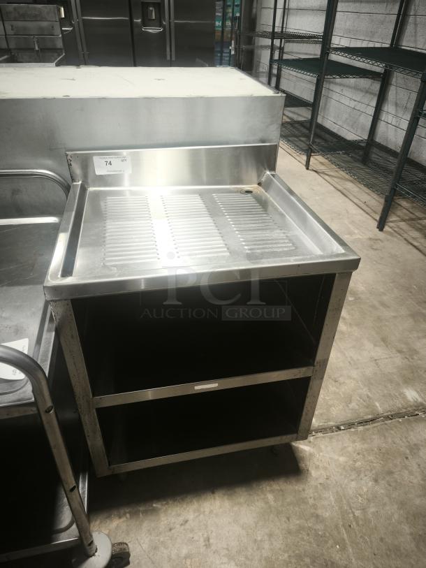 Underbar glass rack storage cabinet with a drainboard top, stainless steel, open shelves, good condition, item 74 tag visible.