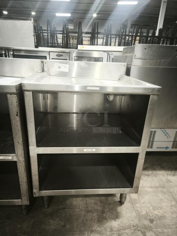 Heavy-duty underbar glass rack storage cabinet, stainless steel, with drainboard top, features dual shelves, good condition.