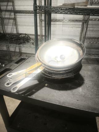 12" stainless clad frying pan with slightly worn surface, visible stacking wear, located on a metal shelf.