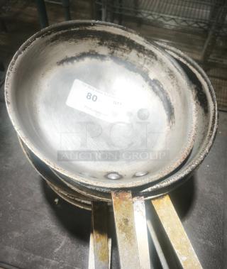 Stainless Clad Frying Pan 12", used condition, visible wear and stains, sticker with auction details, durable construction.