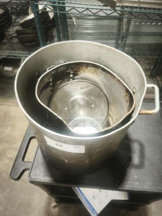 Extra large aluminum stock pot with handle, used condition, visible wear and patina. Auction label marked "84."