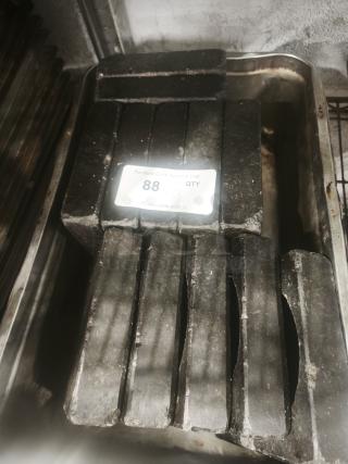 Heavy-duty metal blocks in a tray with visible wear, tag reads "88" by PCI Auctions, indicating auction lot quantity.