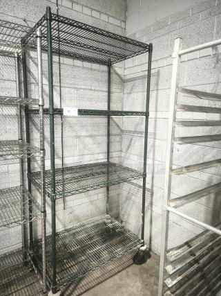 Green epoxy wire shelf with four tiers, in good condition. Features sturdy metal construction and caster wheels for mobility.