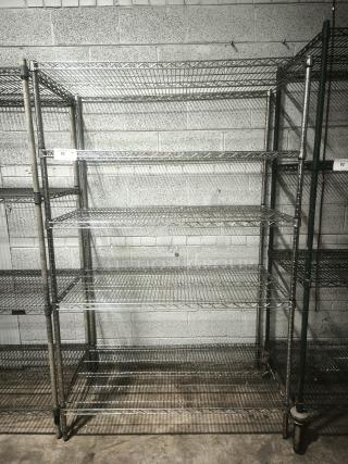 Silver epoxy wire shelf, five-tier, sturdy metal construction, used condition, visible labeling with lot number.