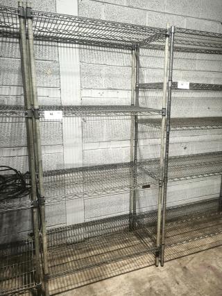 Silver epoxy wire shelf with four tiers, sturdy metal construction, used condition, ideal for storage or display.