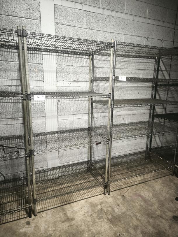 Silver epoxy wire shelf with sturdy metal frame, multiple tiers, and visible product tags for auction. Good condition.