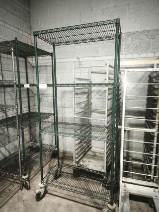 Green epoxy wire shelf on wheels, four-tier, used condition, suitable for storage or industrial use.