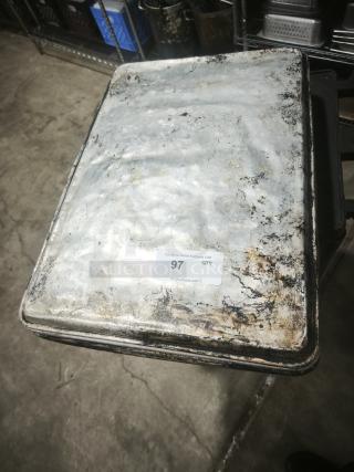 Weathered aluminum cake baking pan, rectangular shape, visible wear and patina. Auction label indicates "97 QTY".