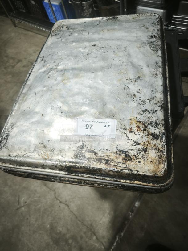 Aluminum cake baking pan with a weathered finish, visible wear and discoloration, auction tag marked "97".