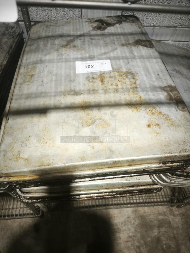 Aluminum cake baking pan with some rust and wear, stackable design. Auction tag "102" attached.