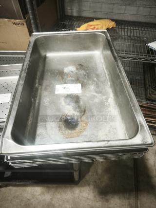 Full-size rectangular food pan with visible wear and some surface marks. Auction tag "104" displayed.
