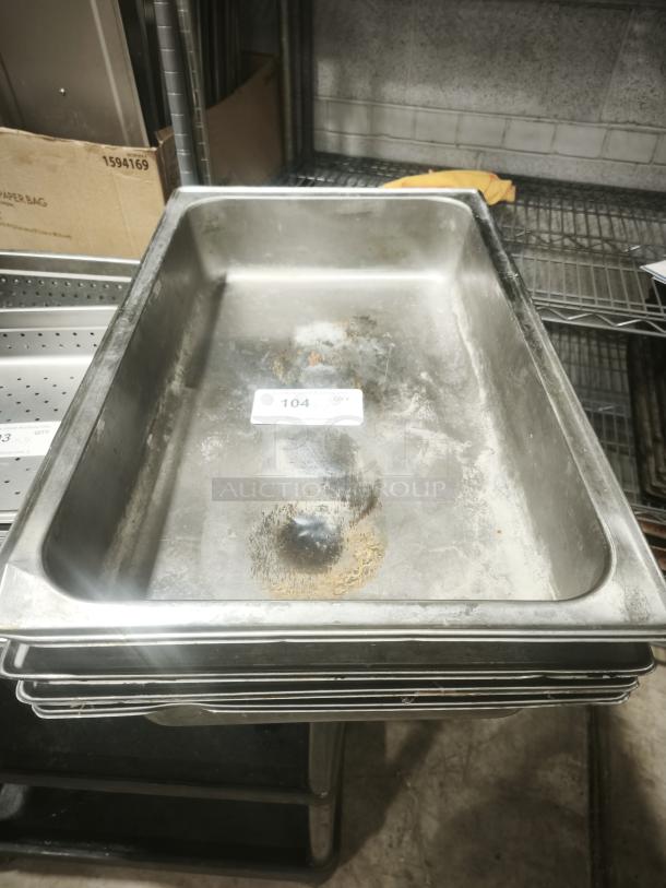 Full-size rectangular food pan, visible wear and discoloration, stackable design. Tag reads "104" and indicates quantity.