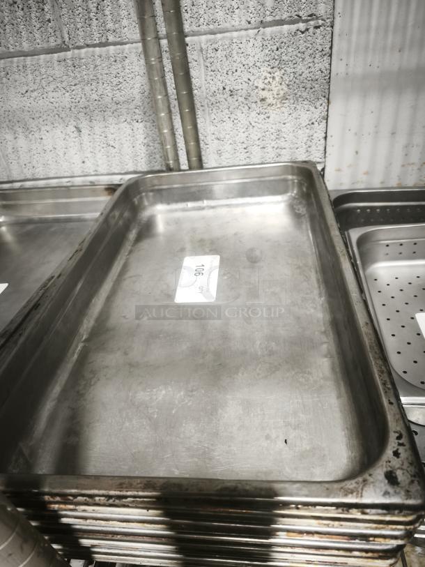 Full-size rectangular food pan, stainless steel, visible signs of use, stackable, marked with item tag "106".