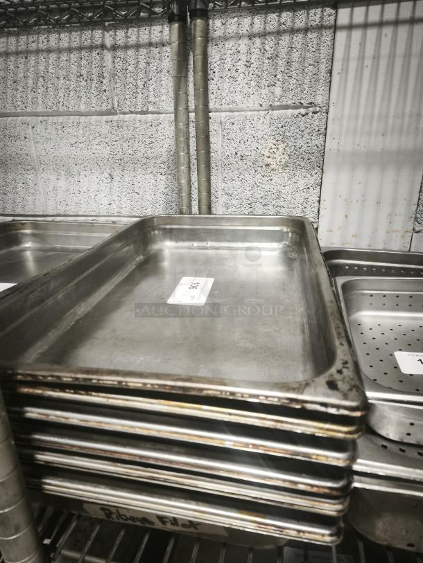 Full-size rectangular food pans stacked, showing visible wear. Label on each pan indicates lot number "1006".