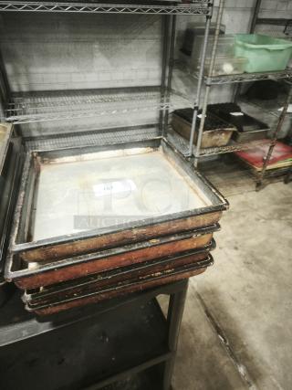 Stack of used 16" cooking pans, worn edges, light rust, with label "107." Suitable for commercial kitchen use.