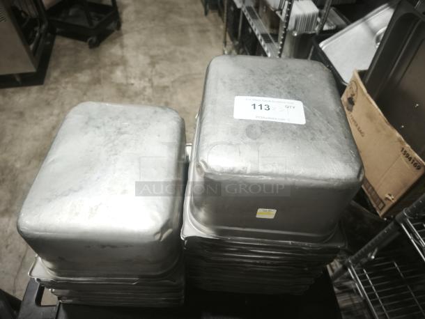 Stainless steel steam table pans, half full size, 6" deep, stacked. Visible label: "113". Used condition.