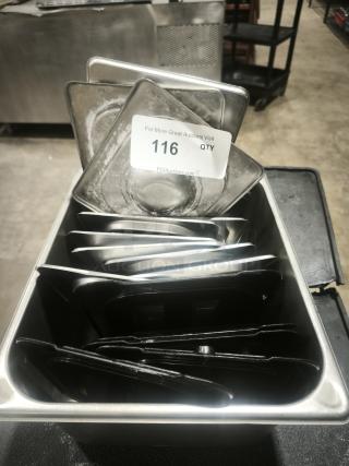 Stainless steel 1/4 full size table pan with slotted lid, used condition. Auction tag 116 attached.