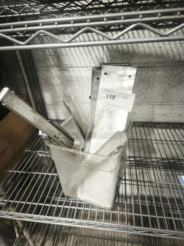 Stainless steel hot and cold table pan dividers in a metal bin. Visible tag reads "118 QTY 6." Good condition.