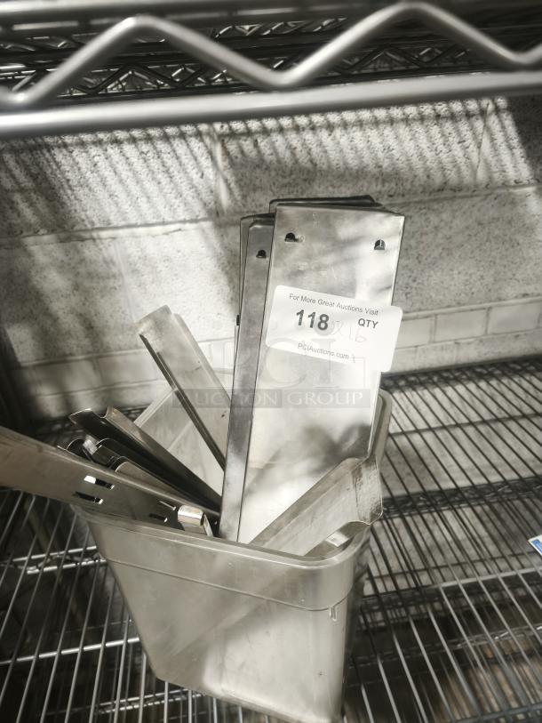 Stainless steel hot and cold table pan dividers in a container, slightly used, labeled "118 x 16 QTY," on a wire shelf.