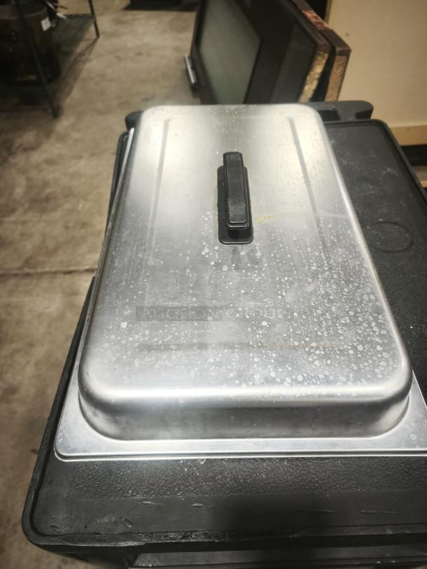 Stainless steel chafing dish with foldable frame, cover lid, and two fuel holders. Used condition.