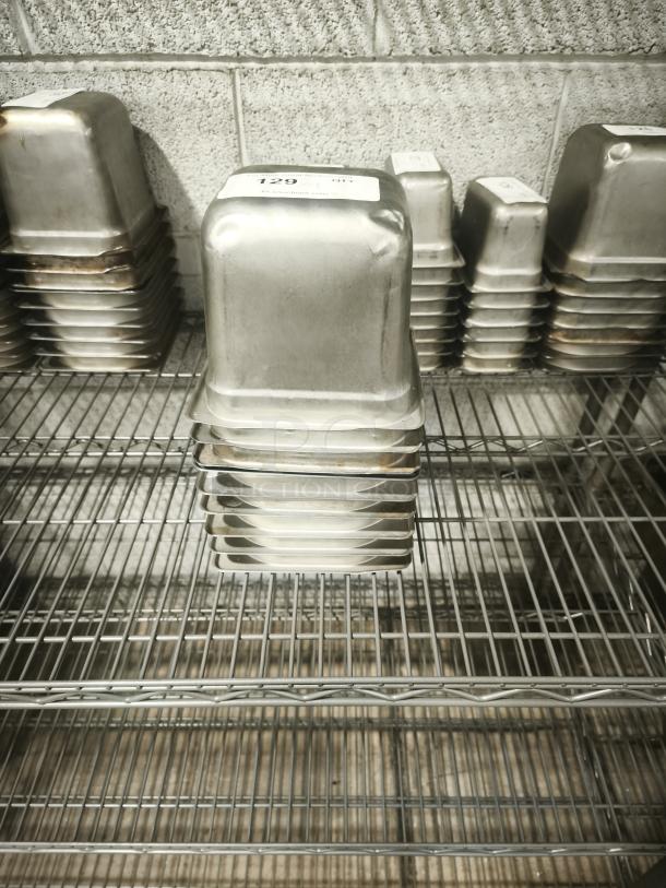 1/9 Size 4" Deep Food Pan, stainless steel, good condition, label marked "129." Ideal for commercial kitchen use.