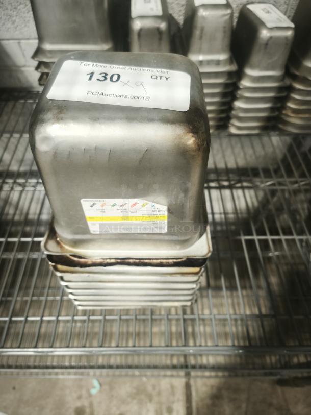 1/6 Size 4" deep food pan, stainless steel, slight wear, auction label with lot number visible, stackable design.