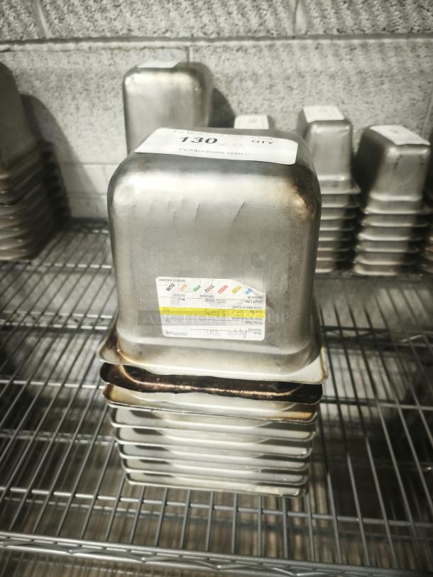1/6 size 4" deep stainless steel food pan on wire shelf, with visible wear. Label shows capacity and usage details.
