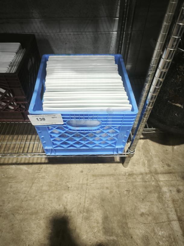 10" bright white square porcelain plates in blue crate on metal shelf, tag indicates quantity. Plates appear in good condition.