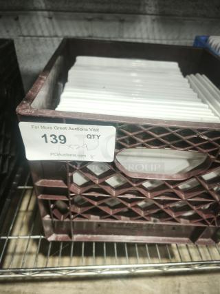 9" bright white square porcelain plates stacked in a brown crate. Excellent condition, ideal for dining presentation.