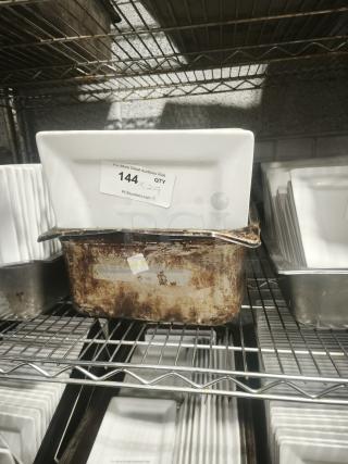 10" bright white square porcelain plate on a metal shelf, with label "144" indicating auction details.