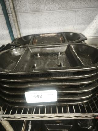 Stack of iron griddle pans with divided sections, showing light wear. Tag reads "152 QTY." Suitable for collection or use.