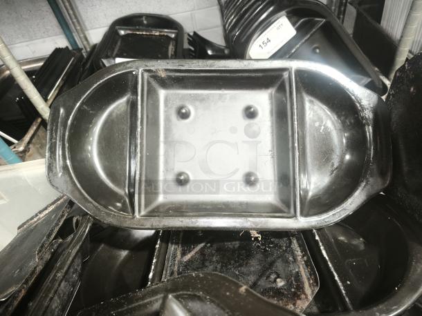 Iron griddle pan, rectangular with rounded edges, shows signs of wear, sturdy construction, suitable for grilling and frying.