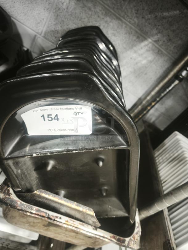 Stack of iron griddle pans, used condition, with auction tag "154 x 3" indicating quantity.