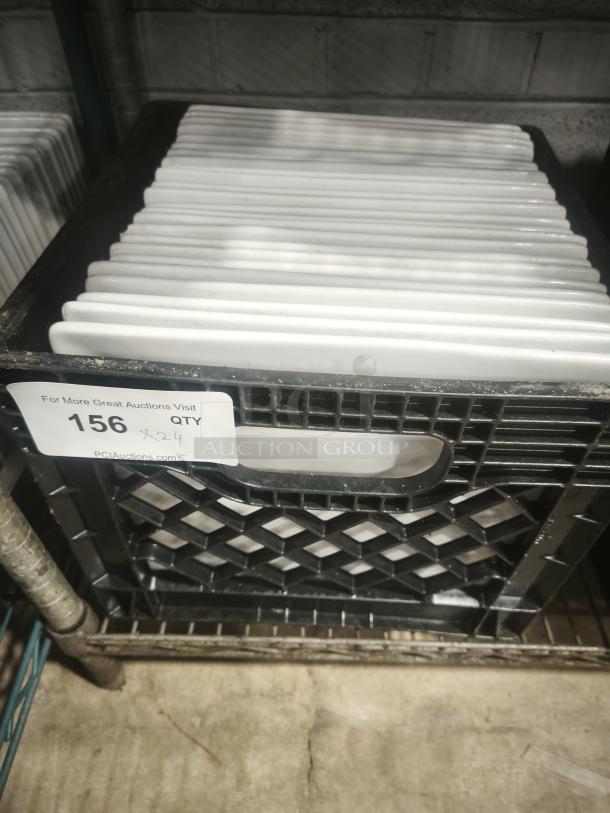 10" bright white square porcelain plates in crate, quantity of 24, displayed on shelf. Auction label visible with lot number 156.