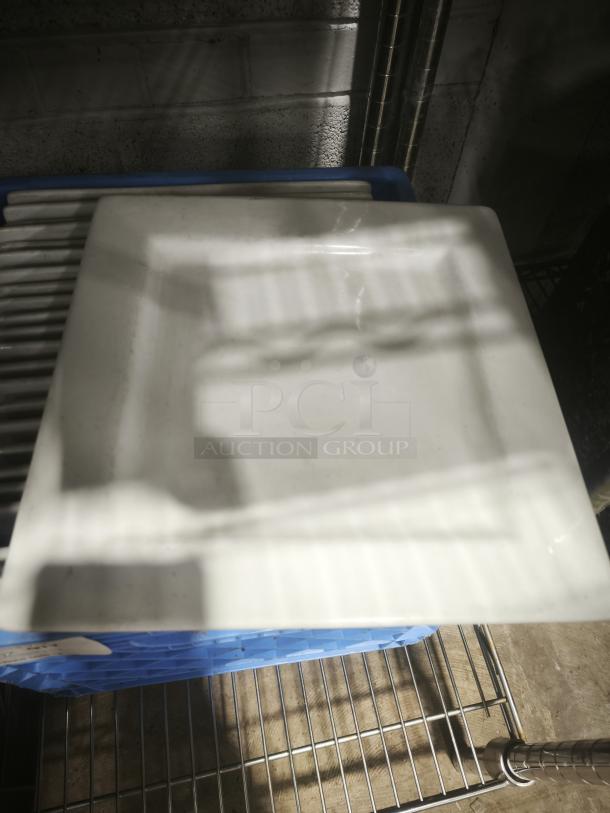 10" bright white square porcelain plate in excellent condition, with sleek design. No visible markings or labels.