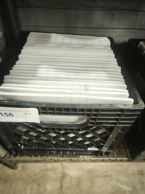 10" bright white square porcelain plates stacked in a crate, pristine condition, auction tag indicates quantity of 24.
