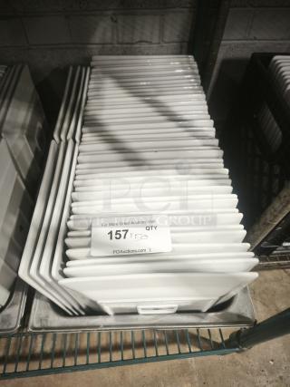9" bright white square porcelain plates stacked. Tag indicates quantity "157." Excellent condition.