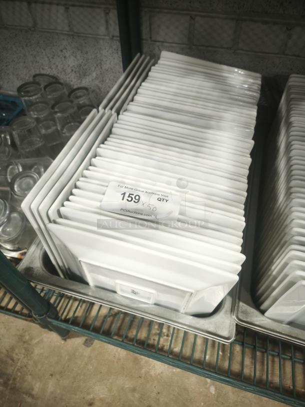 9" bright white square porcelain plates stacked, in excellent condition, with auction info tag indicating quantity of 50.