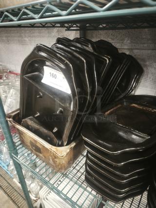 Stack of iron griddle pans with a smooth black finish, slight wear visible. Tag indicates auction item number 160.